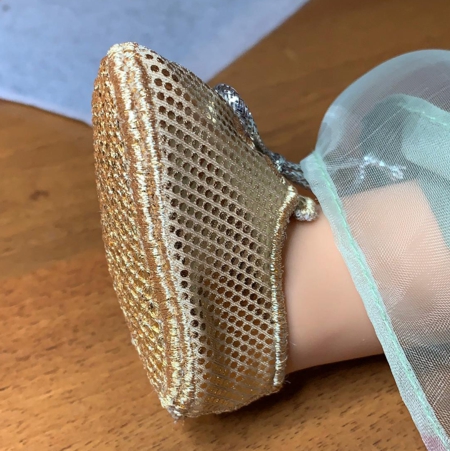 Finished shoe on a doll's foot.