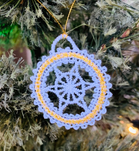 Stitch-out of a circle ornament from the set. Close-up.