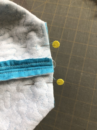 Fold the bag and center the side seam with the bottom central line, align the edges of the cut corner.