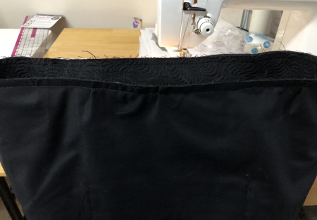 Lining topstitched to the upper edge of the bag.
