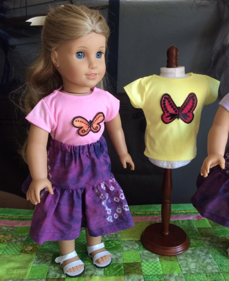 Doll in a t-shirts decorated with butterfly applique