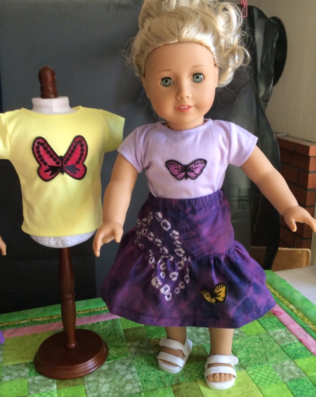 Doll in a t-shirt decorated with butterfly applique