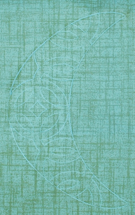 The second color embroiders the same outline over the fabric and the motif inside the outline.