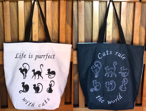 FInished tote , one panel is white with black embroidery, another is black with white embroidery.