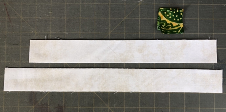 From the 1 1/2" wide light strip, cut 2 strips 12 1/2" long, and 2 strips 14 1/2" long.