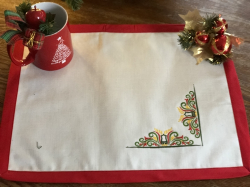 Finished placemats - white fabric, red binding and multi-colored embroidery