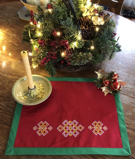 Finished placemats - red fabric, green binding and multi-colored embroidery