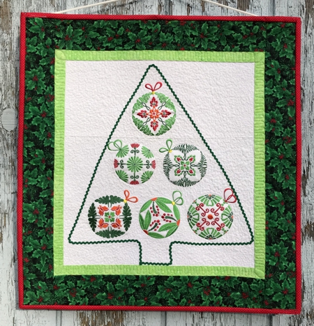 Small Wall Quilt with Christmas Ornaments which shape a Christmas tree.