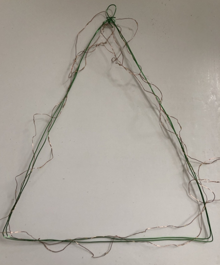 Wire frame wrapped in fairy lights garland.