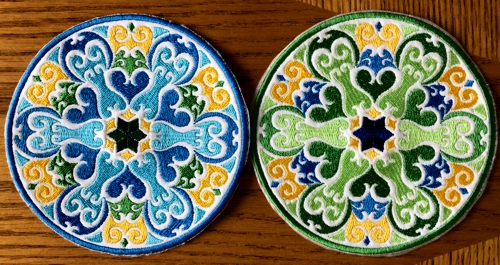 2 coasters embroidered with threads of different colors.