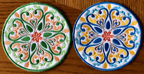 2 coasters embroidered with threads of different colors.