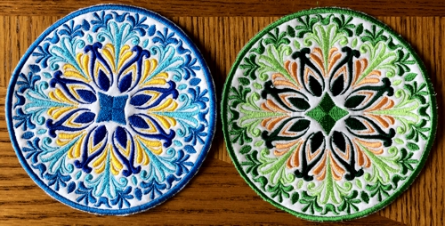 2 coasters embroidered with threads of different colors.