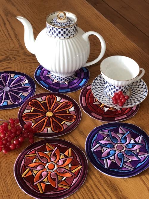 Coasters on a table with tea set.