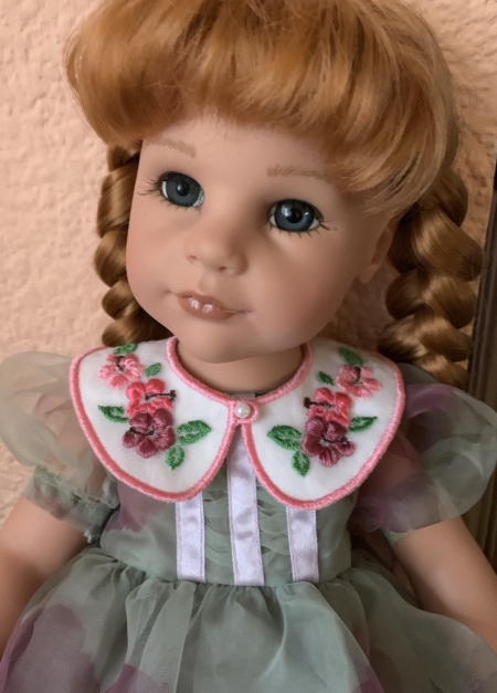 Finished doll collar on a doll.