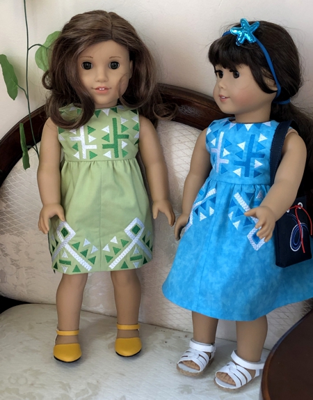 2 finished doll dresseswith embroidery.