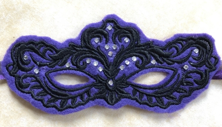 Stitch-out of the mask decorated with crystals.