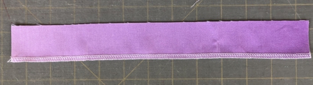 Belt strip with one edge finished.