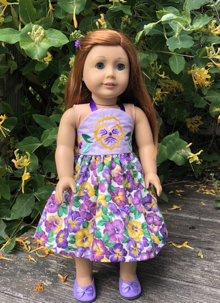 Doll sundress with pansy embroidery.
