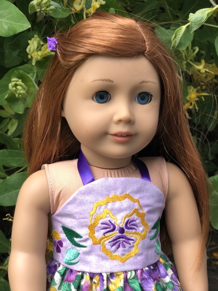 Doll sundress with pansy embroidery. Close-up of the bodice.