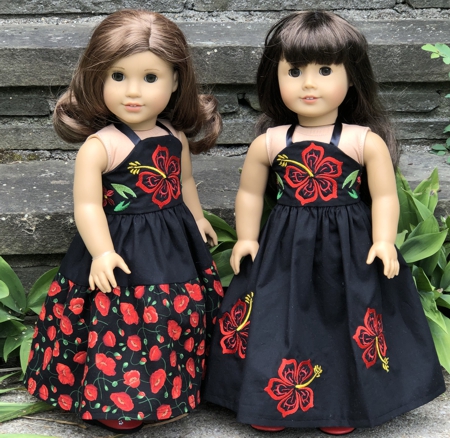 2 long dresses decorated with hibiscus embroidery.