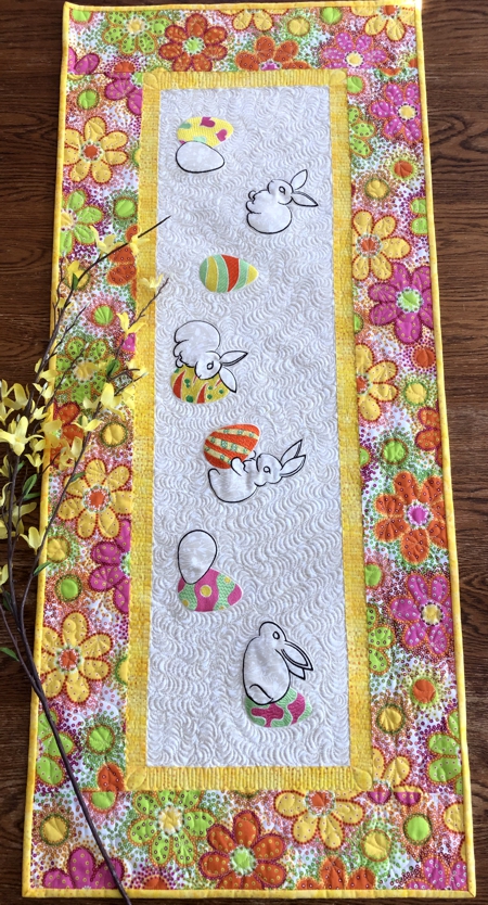 Finished Easter tablerunner with Easter bunny embroidery and eggs.