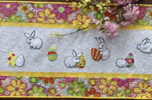 Close-up of theEaster bunny and eggs embroidery on the tablerunner.