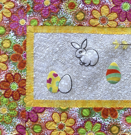 Close-up of the quilting pattern, Easter bunny and eggs embroidery on the tablerunner.