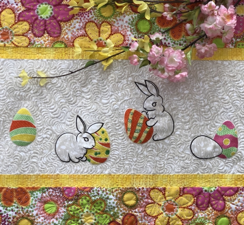 Close-up of the quilting pattern, Easter bunny and eggs embroidery on the tablerunner.