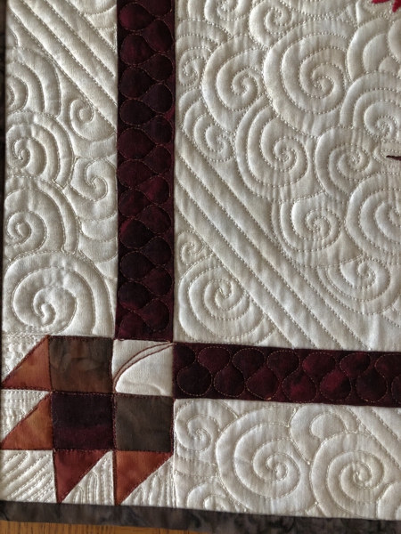 Close-up of the quilting patterns on the quilt.