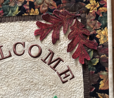 Close-up of freestanding oak leaf embroidery.