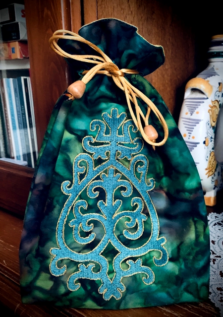 FInished green bag with emerald embroidery.