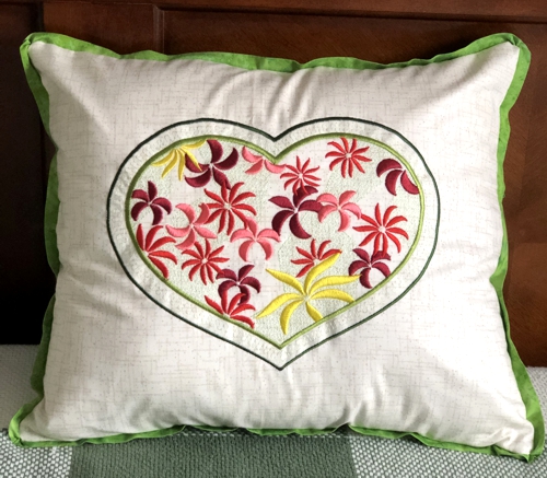 Finished pillow with heart design embroidery.
