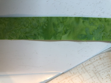 Narrow green strip of fabric.