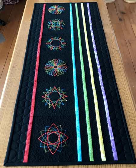 Finished table runner with geometric embroidery.