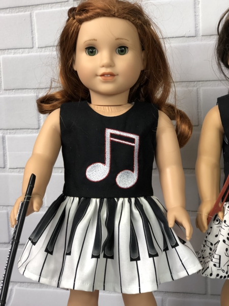 Finished dress with embroidery on bodice modeling by American Girl doll Blaire