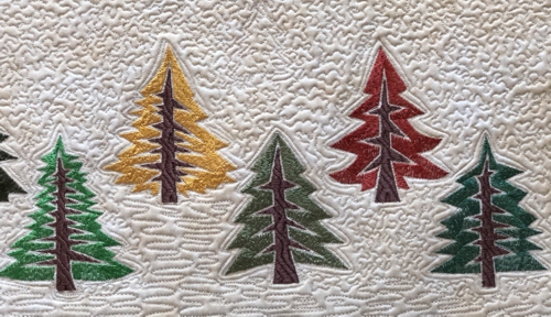 Close-up of the pine trees embroidery.