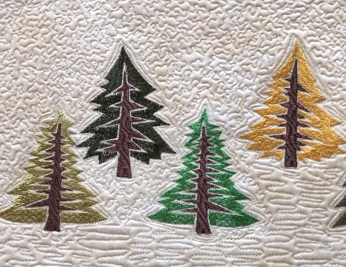 Close-up of the pine trees embroidery.