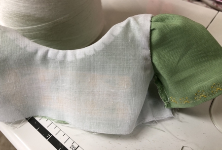 Fold the lining edge under and stitch by hand to the seam allowance of the sleeve.