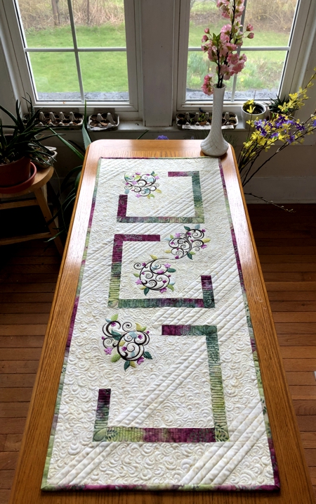 Quilted tablerunner with floral machine embroidery