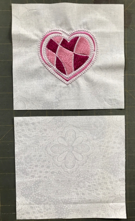 A square with the stitch-out of the heart and a square for the backing.