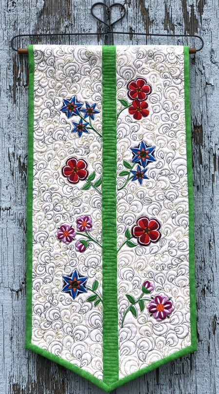 Finished wallhanging with flower embroidery.