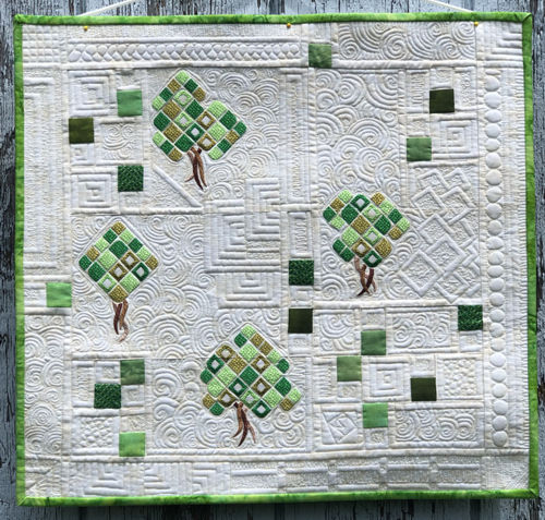 Finished quilted wallhanging with tree embroidery