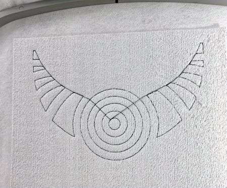 Outline of the necklace over the puffy layer.