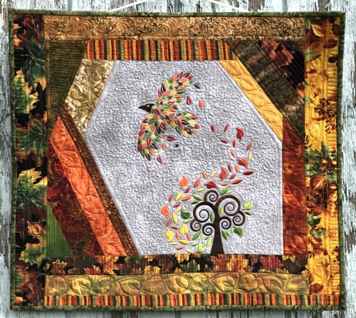 Finished wall quilt with fall tree and raven embroidery