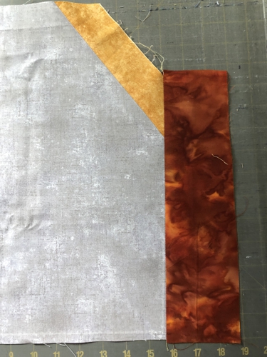 The cut-out of the quilt's center and the second border attached.