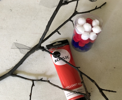 Dry twigs, red paint and pom-poms
