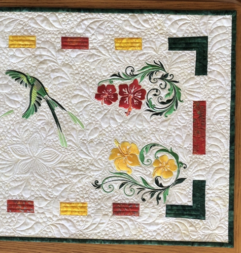 Close-up of the embroidery, quilting patterns, and binding.
