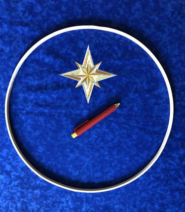 Position the lower hoop over the fabric so that the star is close to the upper edge