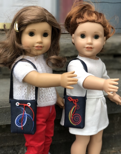 2 dolls carrying the cork bags with embroidery.