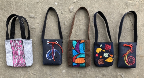 Doll-sized bags with embroidery.